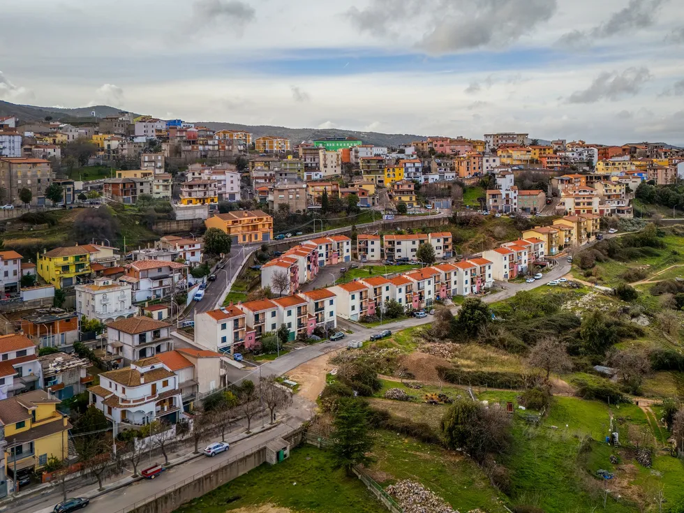 Tightly built village on a hillside with mostly three- to five-story buildings