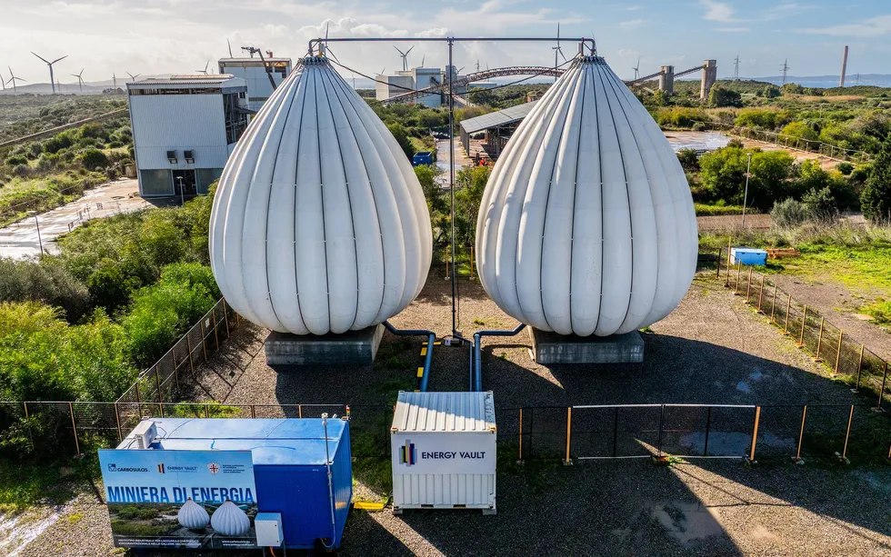 Two photos, one showing two pear-shaped tanks, each the size of a house resting above ground.