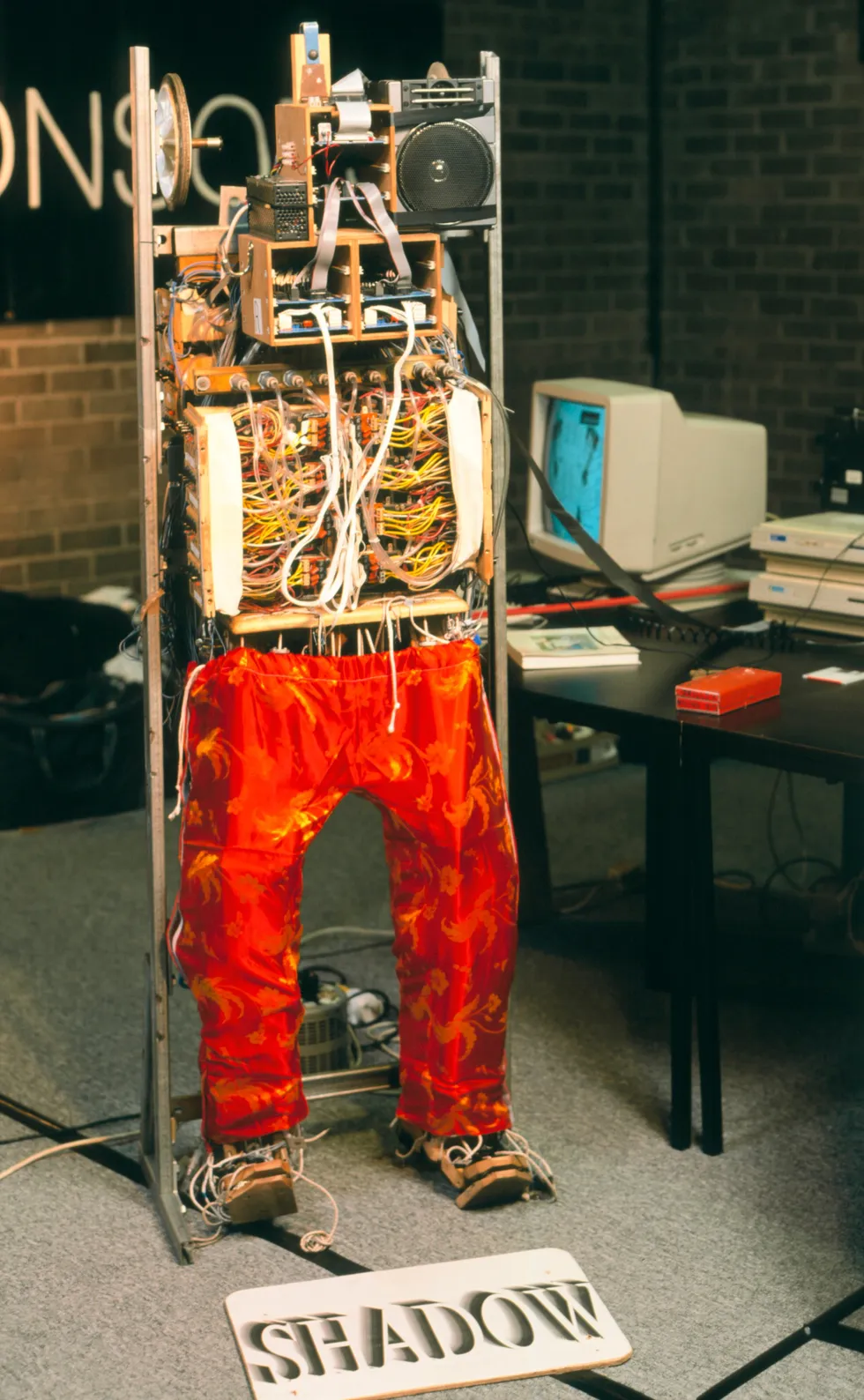 Photo of a headless and armless humanoid robot wearing red pants.