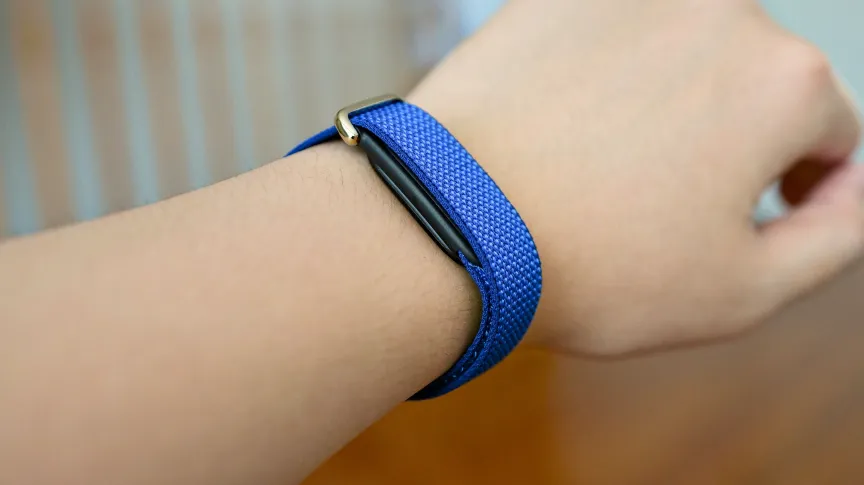 A blue Fitbit Air on the wrist.