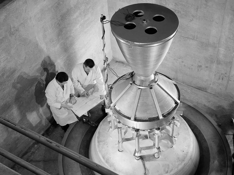 A photograph of a squat nozzle standing on a rig in a concrete test chamber, 