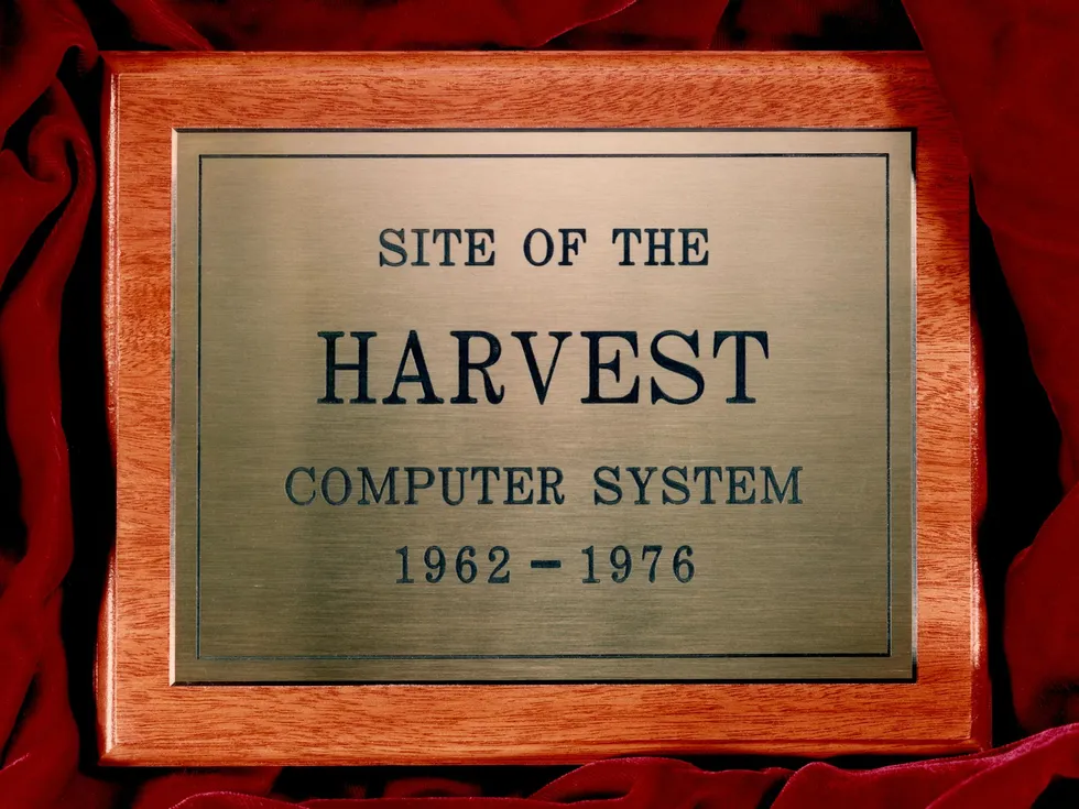 A wooden plaque with an etched bronze plate that reads \u201cSite of the Harvest computer system, 1962-1976"  