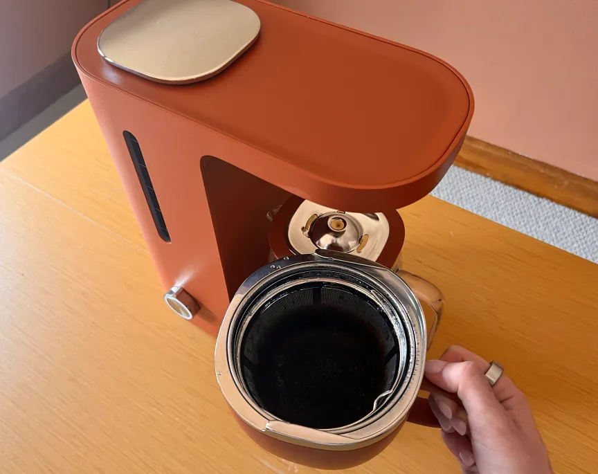 a person holding a coffee brew basket