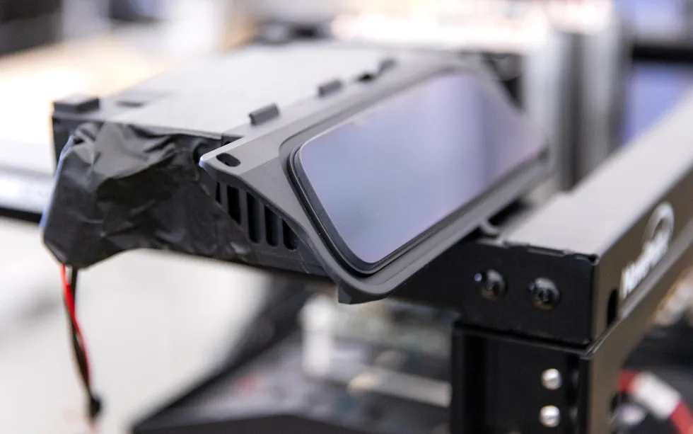 An enclosure with a trapezoidal front sensor and a twisted pair of wires connected to the back.