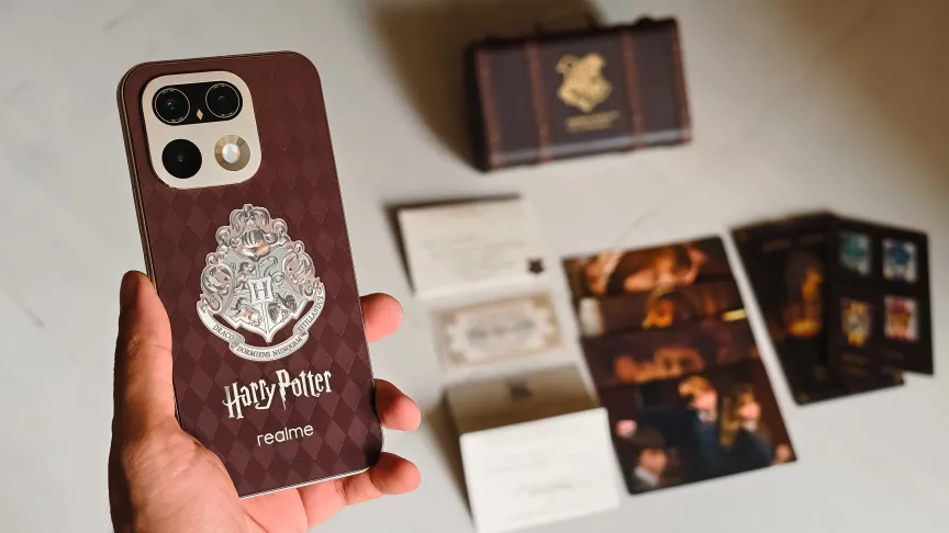 Prakhar Khanna holding the Realme 16 Pro 5G Harry Potter Edition phone with its goodies in the background.