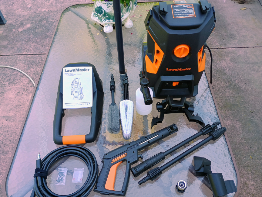 The LawnMaster LT506-2000A power washer set on a glass table with all of its included accessories.