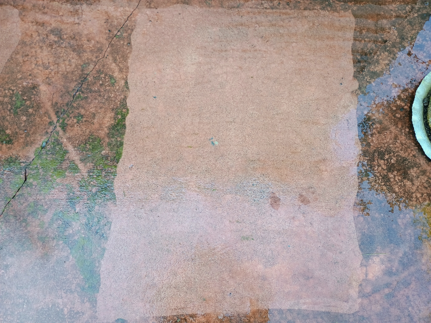 A section of pavement after it was cleaned with the LawnMaster LT506-2000A power washer. It's much cleaner, and there are only a few areas that would require a second pass with the washer.