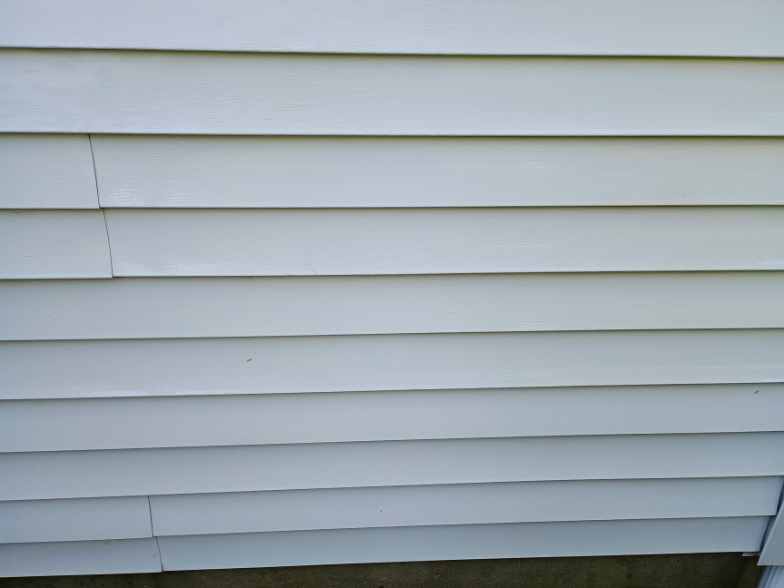 A view of house siding after it was cleaned with the AR Blue Clean pressure washer. The result looks very clean.