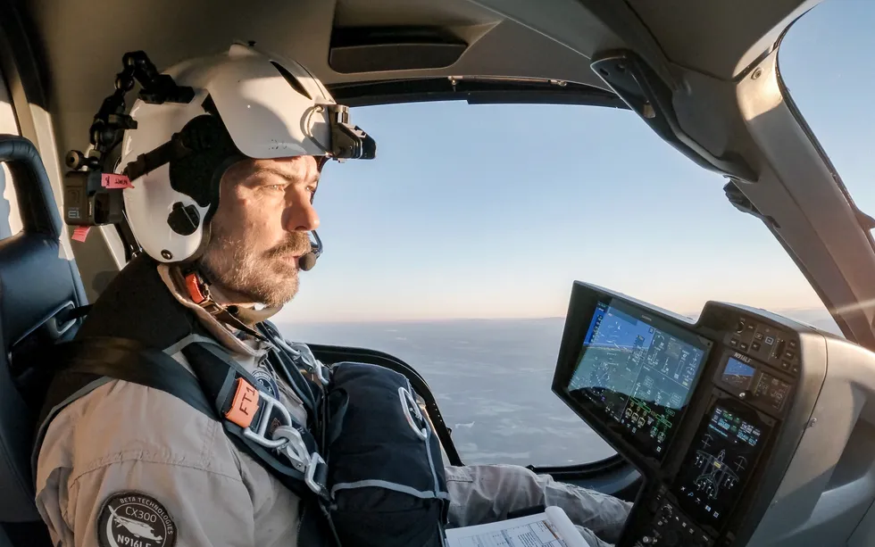 A photo showing a bearded white man wearing a helmet and piloting an aircraft