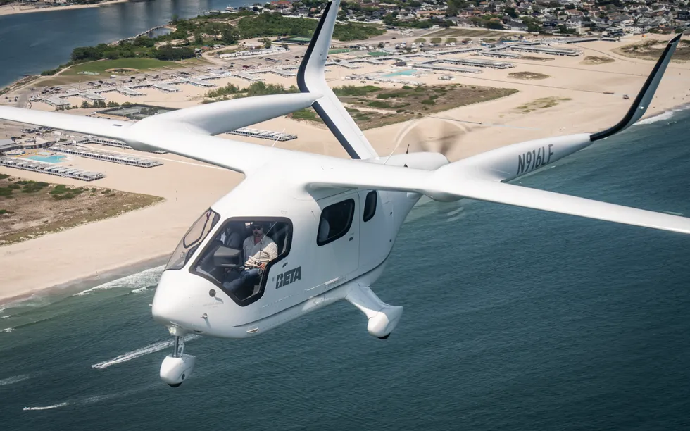  A photo showing a small white plane flying above a shoreline