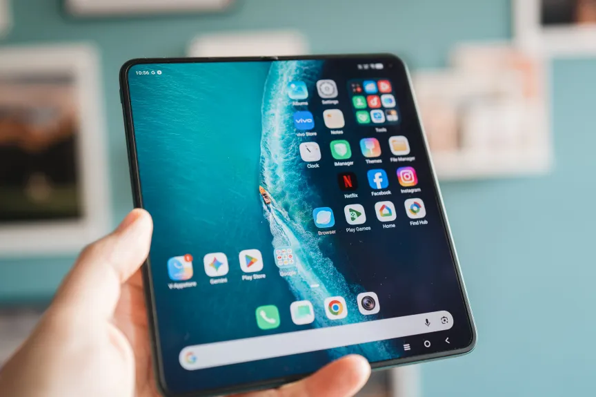 A hand holds an unfolded Vivo X Fold 6, drawing attention to the screen.